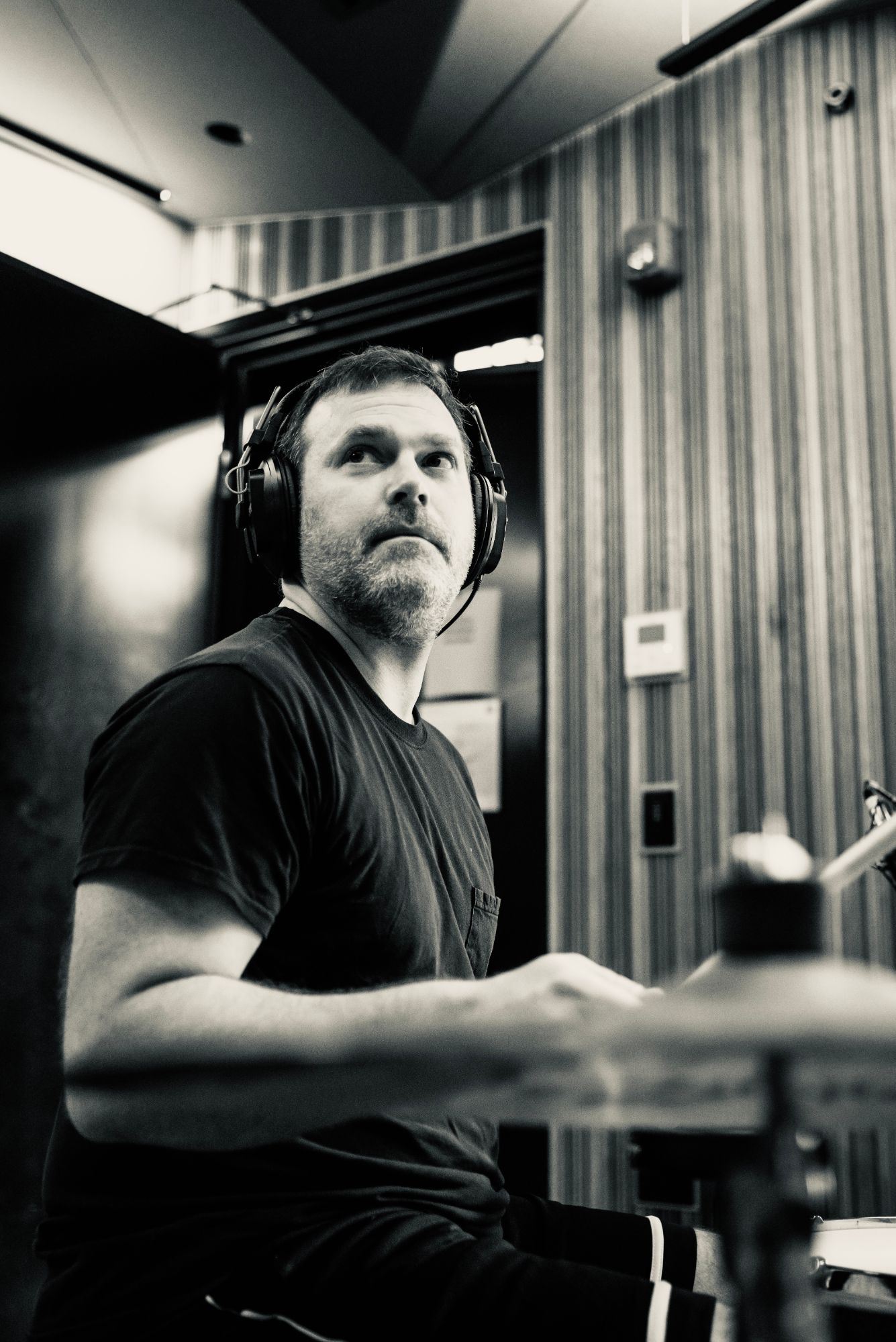Ritual Machine drummer in the studio, wearing headphones