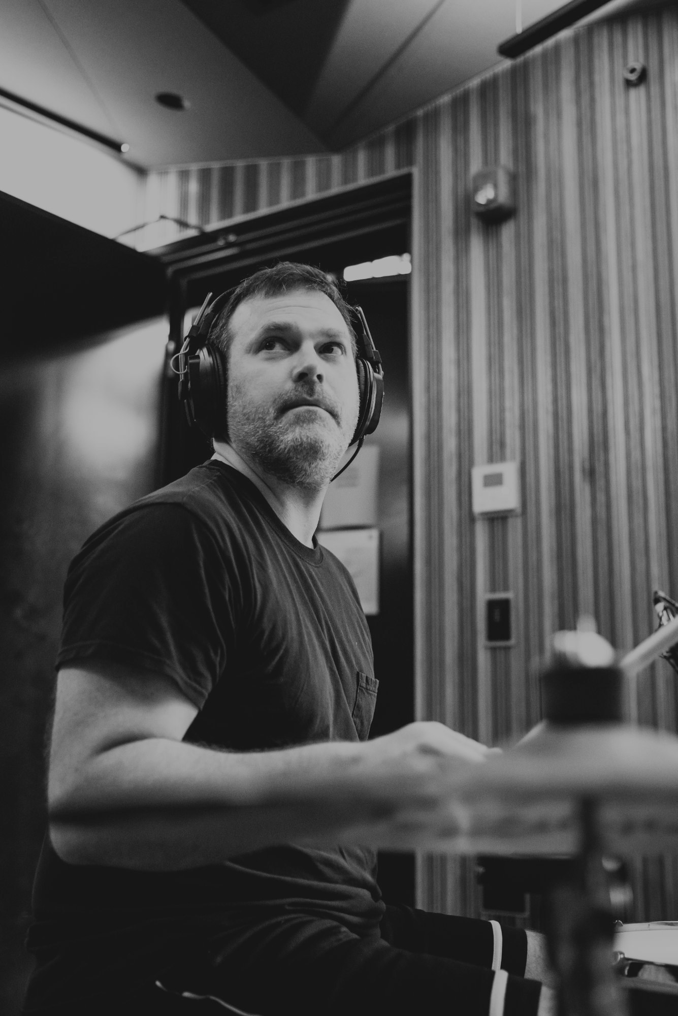 Drummer in the studio, wearing headphones